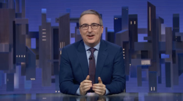 John Oliver Denounces Pete Hegseth’s Comments Celebrating David Ellison’s CNN Takeover & White House’s Iran War “Hype Videos”