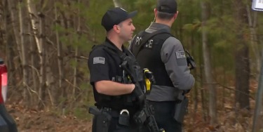 Massive manhunt underway in New Hampshire town after gunman allegedly wounds police officer, fires on family
