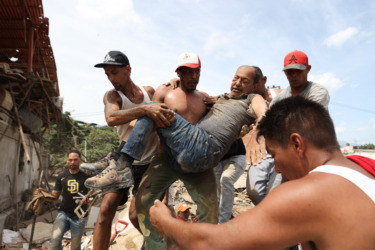 Neighbors dig through Venezuela rubble to search for loved ones