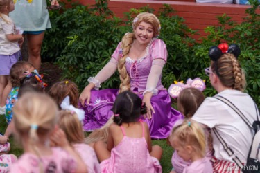 Enchanting Disney princess Rapunzel entertaining children at Disney World event.