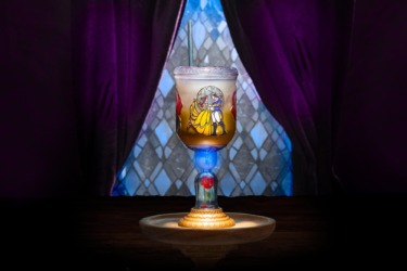Colorful Disney-themed goblet with a character design and layered drink inside.