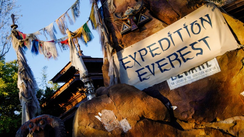 A broken railroad track and a snowcapped mountain at Expedition Everest